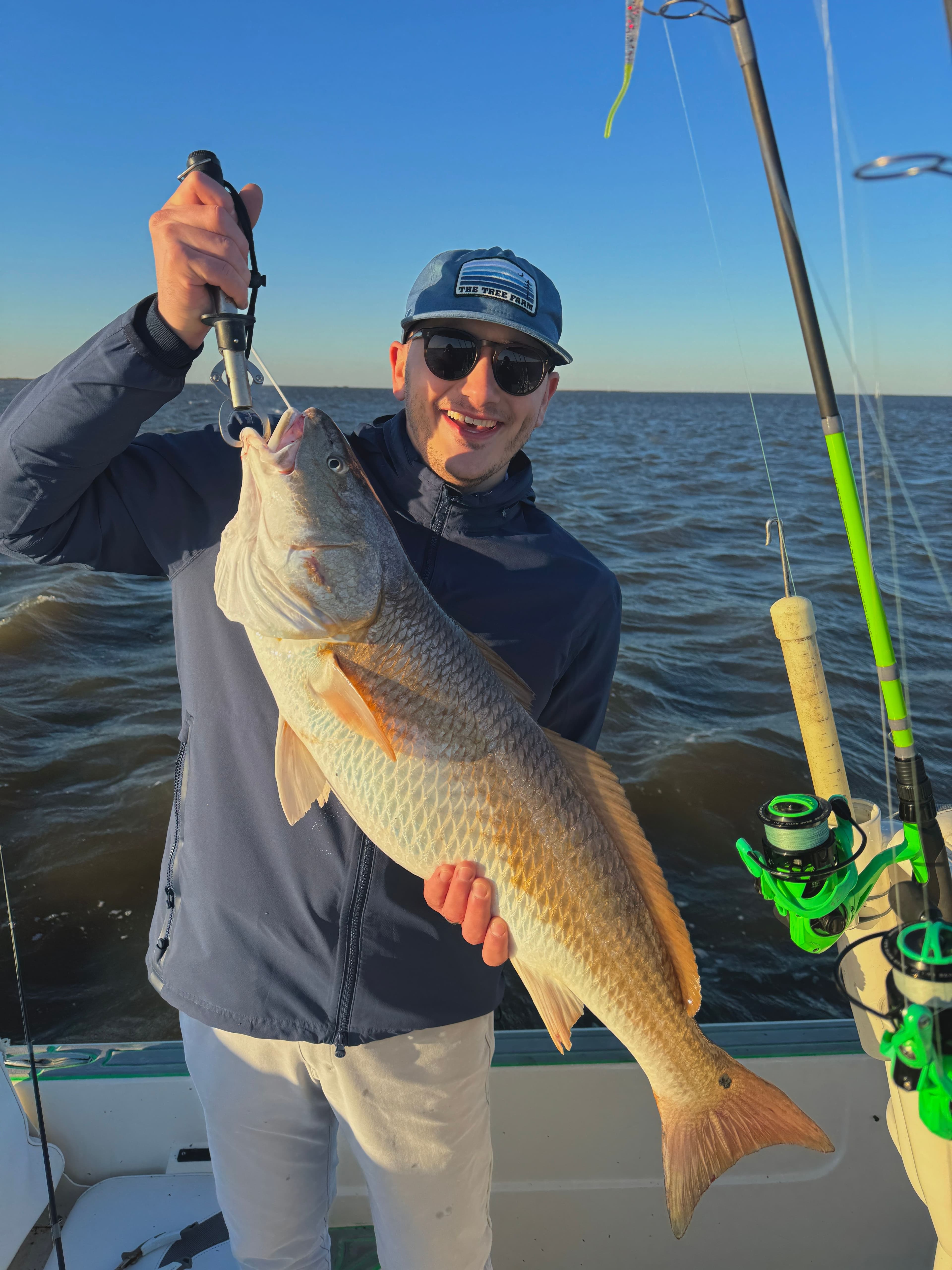 Mason Coy holding a redfish on a fishing trip